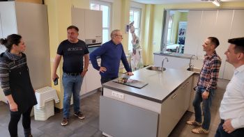 Fünf Personen stehen in eine Lehrküche